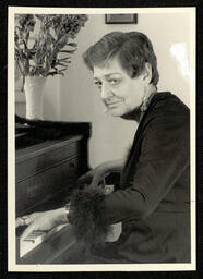 Janet MacHarg playing piano with flower vase, circa 1990