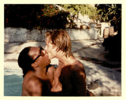 Photograph of Sylvester kissing a companion, believed to be his partner Rick Cramer.
