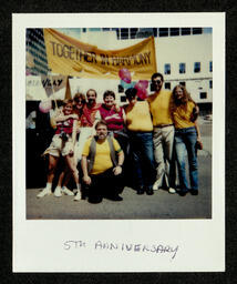 Photograph of a group of chorus members gathering during their 1985 reunion at the San Francisco Pride parade.