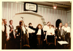 Photograph of the Lesbian and Gay Chorus of San Francisco ensemble, Vocal Minority performing at Valencia Rose. 