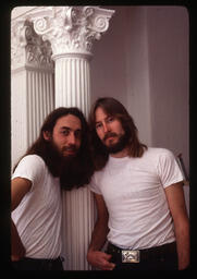 Gilbert Baker and a partner posing together in white t-shirts. The photograph is unattributed, but in the style of Jean-Baptiste Carhaix, who knew and often photographed Baker.