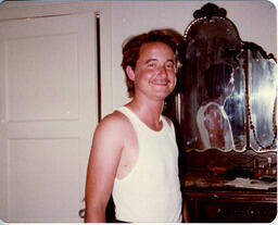 A flash photo of Lou Sullivan in a white undershirt, sent to his correspondent, a trans man named David.