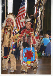 Members of Bay Area American Indian Two Spirits (BAAITS) in traditional dress at a powwow. 