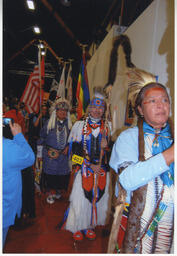Bay Area American Indian Two Spirits (BAAITS) members preparing to dance at a powwow event. 