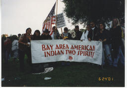 Members of Bay Area American Indian Two Spirits (BAAITS) at a pre-San Francisco Pride parade event carrying a BAAITS banner. 